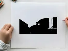 Silhouette of a semi truck driving down a road at sunset