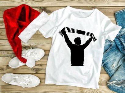 A silhouette of a person holding a scarf above their head in celebration