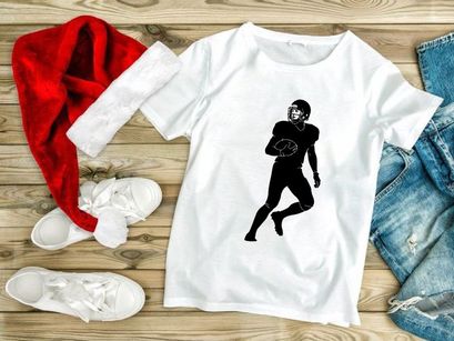 American football player in motion running with ball