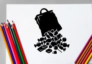 Silhouette of a spilled bag of chocolates and candies on white background