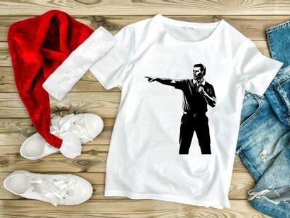 A man in a black shirt pointing to the left with a microphone