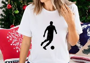 Soccer player kicking a ball in action silhouette
