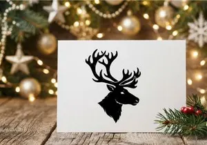 Black silhouette of a deer head with large antlers isolated on a white background.