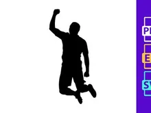 A man in a yellow shirt jumping up with his arm raised in celebration