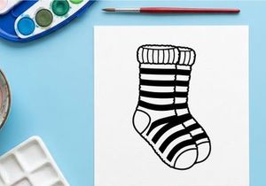 Cute striped Christmas sock with toe hole isolated on white background for festive holiday decor