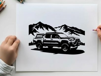 Silhouette of a rugged pickup truck in front of majestic mountains