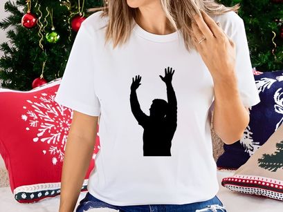 A person standing with arms raised up in the air in a gesture of praise or celebration