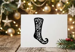 Black Christmas stocking silhouette with intricate floral filigree and star patterns.