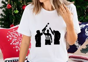 Silhouette of three men playing volleyball with referee