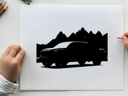 Silhouette of a pickup truck in front of mountains