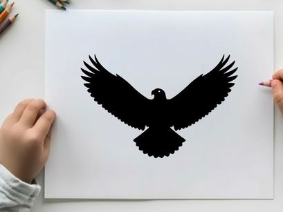 Black silhouette of an eagle in flight with wings spread wide