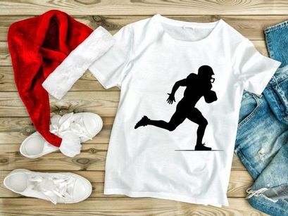 American football player running with ball in hand silhouette