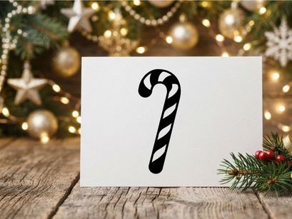 Black and white candy cane icon isolated on a white background for holiday design.