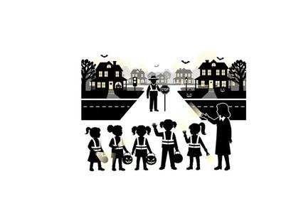 Silhouette of children and teacher crossing the road at night