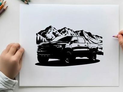 Silhouette of a pickup truck in front of snowy mountains