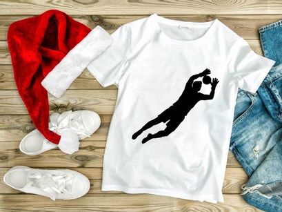 Silhouette of a person diving to hit a ball