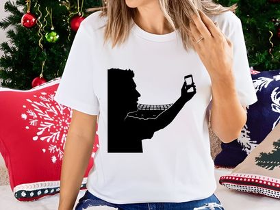 Silhouette of a man taking a photo with his smartphone and a keyboard