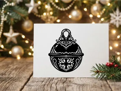 Decorative Christmas jingle bell icon with ornate filigree pattern on white background.