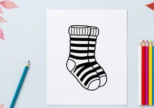 Cute striped Christmas sock with toe hole isolated on white background for festive holiday decor