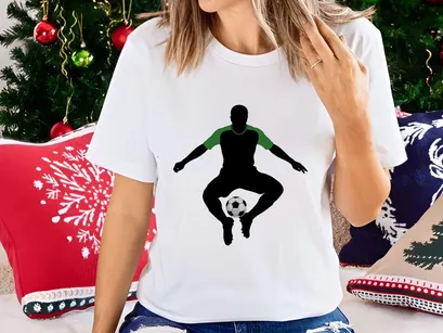 Soccer player in mid air balancing ball on foot in green and black silhouette