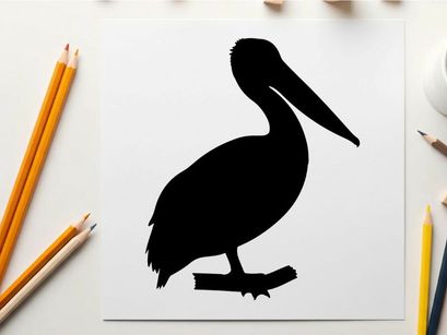 Silhouette of a pelican standing on a branch