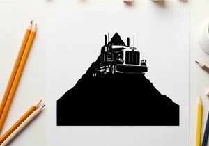 Silhouette of a semi truck on a hill