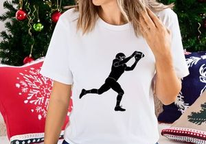 American football player catching a ball in mid air during a game