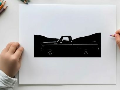 Silhouette of a classic pickup truck against a mountainous backdrop silhouette