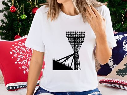 A large stadium light tower against a white sky background silhouette