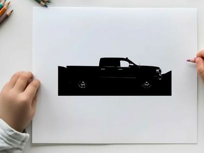 Silhouette of a pickup truck against a mountainous landscape