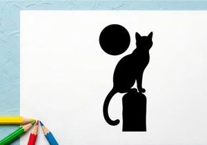 Silhouette of a Cat Sitting on a Block with a Full Moon in the Night Sky