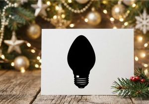 Black silhouette of a classic light bulb isolated on a white background.