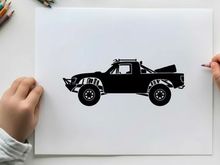 Silhouette of a pickup truck with a palm tree in the back