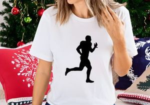 Silhouette of a football player running with the ball