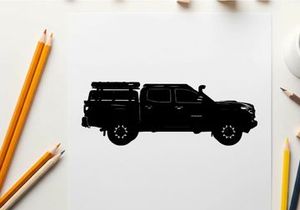 Silhouette of a pickup truck with a camper on the back
