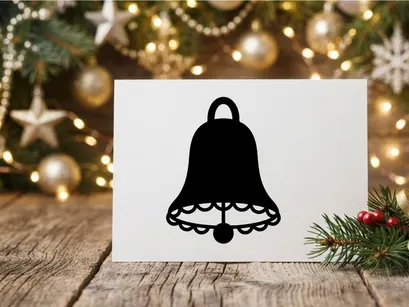 Black silhouette of a Christmas bell icon isolated on a white background