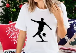 Silhouette of a soccer player kicking a ball in mid action