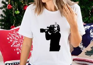 A person holding a video camera and recording
