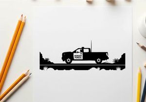 Silhouette of a pickup truck driving on a road with trees