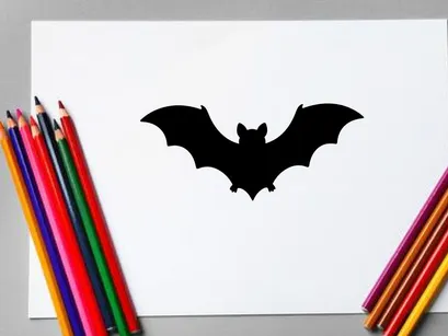 Silhouette of a Bat in Flight for Halloween or Nighttime Themes
