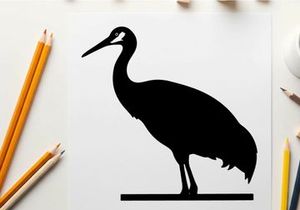 Silhouette of a standing heron bird in profile view