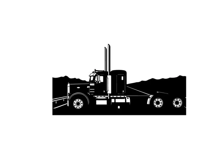 Silhouette of a semi truck on a highway with mountains