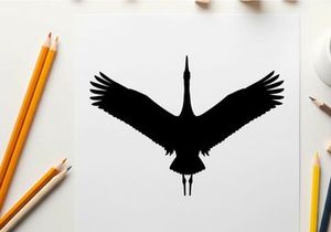 Silhouette of a bird in flight with outstretched wings and long neck