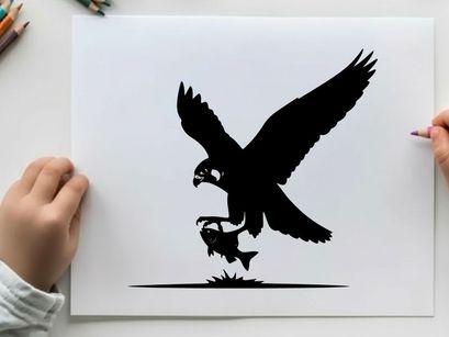 Silhouette of an eagle catching a fish in mid air