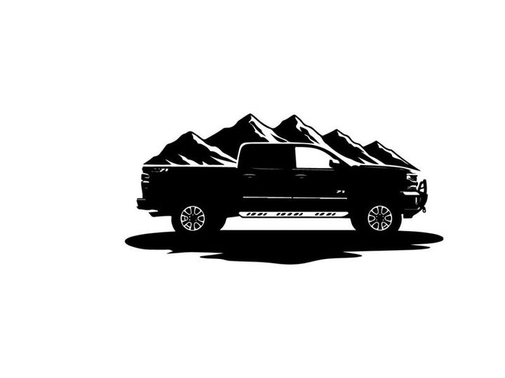 Silhouette of a pickup truck in front of mountains