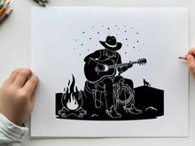 Cowboy silhouette playing guitar by campfire at night