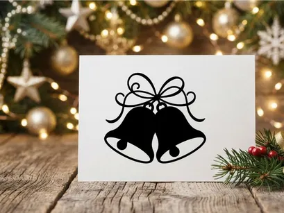 Black silhouette of Christmas bells with a decorative bow isolated on white background