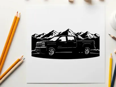 Silhouette of a pickup truck in front of mountains