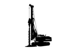 Silhouette of a large drilling machine with a long screw drill