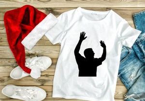 A silhouette of a man with his hands raised up in the air
